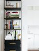 Modern home with Kitchen, Stone Slab Backsplashe, White Cabinet, Engineered Quartz Counter, Dark Hardwood Floor, Ceiling Lighting, Drop In Sink, and Dishwasher. Detail of bookcase. Photo 7 of Brooklyn Heights Glam Apartment