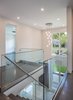 The glass railing system takes full advantage of the bright atrium and view into the large yard beyond. Photo 3 of Shadow on White Pallet modern home