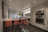 Modern home with Kitchen, Ice Maker, Wall Oven, Dark Hardwood Floor, Dishwasher, Cooktops, Refrigerator, Engineered Quartz Counter, Microwave, Undermount Sink, and Recessed Lighting. Living Space Photo 7 of Hobbit House