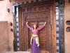 Front door with Eliane,door from 1880 India-Pakistan border, redwood columns from the great fire in San Franciso Photo 6 of Picture Rock Studio-Round Strawbale Home design & built by Glen Neff modern home