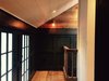 Photo shows the blending of wide plank oak flooring, charcoal trim features, and white tongue and groove bead board ceiling. Vintage Brass Sconce. Photo 9 of The Red Barn modern home