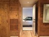 Old Barn plank flooring was reused as wall panels and interior doors. The surface of the planks were brush sanded and installed naturally without any coating. Photo 10 of The Red Barn modern home