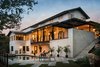 Modern home with Outdoor, Shrubs, Grass, Back Yard, Large Pools, Tubs, Shower, Swimming Pools, Tubs, Shower, Concrete Patio, Porch, Deck, and Metal Fences, Wall. Exterior - pool Photo 5 of River Garden Trail Residence