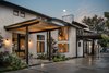 Modern home with Outdoor, Front Yard, Hardscapes, Shrubs, and Landscape Lighting. Front exterior Photo 3 of River Garden Trail Residence