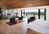 Modern home with Bedroom, Bed, Light Hardwood Floor, Chair, and Recessed Lighting. Master bedroom loft Photo of River Garden Trail Residence