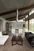 Modern home with Living Room, Standard Layout Fireplace, Gas Burning Fireplace, Concrete Floor, Sofa, Coffee Tables, Track Lighting, and Chair. Glass Farmhouse | Olson Kundig Photo 7 of Glass Farmhouse