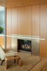 Modern home with Living Room, Chair, End Tables, and Gas Burning Fireplace. Harbor Loft | Olson Kundig Photo 10 of Harbor Loft