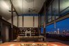 Modern home with Living Room, Chair, Sofa, Sectional, Coffee Tables, Console Tables, Bookcase, Pendant Lighting, Ceiling Lighting, Recessed Lighting, Concrete Floor, and Standard Layout Fireplace. Meg Home | Olson Kundig Photo 6 of Meg Home