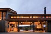 Modern home with Dining Room, Table, Concrete Floor, Pendant Lighting, Recessed Lighting, Chair, Bar, Stools, Two-Sided Fireplace, and Wood Burning Fireplace. Trout Lake | Olson Kundig Photo 10 of Trout Lake