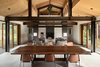 Modern home with Dining Room, Chair, Two-Sided Fireplace, Table, Concrete Floor, Pendant Lighting, and Wood Burning Fireplace. Trout Lake | Olson Kundig Photo 7 of Trout Lake