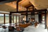 Modern home with Living Room, Sofa, Sectional, Two-Sided Fireplace, Concrete Floor, Coffee Tables, Pendant Lighting, Table, Console Tables, Rug Floor, Wood Burning Fireplace, and Chair. Trout Lake | Olson Kundig Photo 8 of Trout Lake