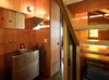Modern home with Bath Room. Agate Pass Cabin | In the powder room, a former hospital cart was redesigned into a stainless steel sink and cabinet | Glass relites in the staircase risers act as a window providing natural light and views into the garden. Photo 10 of Agate Pass Cabin