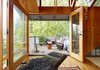 Modern home with Outdoor, Rooftop, and Decking Patio, Porch, Deck. Agate Pass Cabin | A porch was added providing an outdoor room with views of Agate Pass | 'Longbranch Chairs' designed by Jim Olson, Olson Kundig. Photo 15 of Agate Pass Cabin