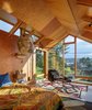 Modern home with Accent Lighting. Agate Pass Cabin | View from bedroom loft to Agate Passage | Jib Light designed by Jamie Slagel, an associate at Olson Kundig | Artwork: Scott Fife creates his three-dimensional work out of sheet rock, metal screws, cardboard and sheetrock mud. 'Big Ed' is a larger-than-life bust of the Spokane-born artist Ed Kienholz. Photo 16 of Agate Pass Cabin