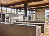 At this home in Sun Valley, the clients wanted a modern house that would feel authentic to the high desert mountain landscape, in a style dubbed "mountain industrial." Everything that touches the earth is stone and board-formed concrete, and everything that projects out is steel and glass, down to the kitchen island, which features two levels, an integrated sink, custom cabinetry, and polished nickel hardware. Photo 13 of Bigwood Residence modern home