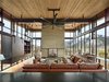 Modern home with Living Room, Bookcase, Console Tables, Sectional, End Tables, Sofa, Chair, Two-Sided Fireplace, and Coffee Tables. Bigwood Residence | Olson Kundig Photo 11 of Bigwood Residence