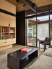 Modern home with Living Room, Console Tables, Sofa, Chair, and Bookcase. Bigwood Residence | Olson Kundig Photo 19 of Bigwood Residence