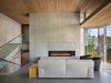 Modern home with Living Room, Table Lighting, Chair, Gas Burning Fireplace, Concrete Floor, and Sofa. Cliff Dwelling | Olson Kundig Photo 9 of Cliff Dwelling