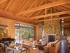 Modern home with Living Room, Coffee Tables, Sofa, Two-Sided Fireplace, Bookcase, Chair, and Console Tables. Country Garden House | Olson Kundig Photo 8 of Country Garden House