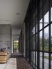 Modern home with Living Room, Dark Hardwood Floor, Chair, and Two-Sided Fireplace. Millerton Farmhouse | Olson Kundig Photo 8 of Millerton Farmhouse