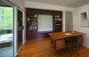 Modern home with Library, Chair, Desk, Study, Lamps, Storage, Shelves, Medium Hardwood Floor, Living Room, Ceiling Lighting, and Table Lighting. Frontenac House - Office Photo 9 of Frontenac House