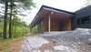 Modern home with Outdoor, Boulders, Grass, Front Yard, and Trees. Frontenac House - Exterior Photo of Frontenac House