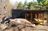 Modern home with Outdoor, Large Patio, Porch, Deck, Wood Patio, Porch, Deck, Concrete Patio, Porch, Deck, Trees, Boulders, and Shrubs. Frontenac House - Exterior Photo 4 of Frontenac House