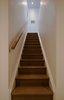 Modern home with Wood Railing, Wood Tread, Living Room, Ceiling Lighting, and Medium Hardwood Floor. Guelph Deep Energy Retrofit - Staircase Photo 13 of Guelph Deep Energy Retrofit