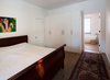 Modern home with Medium Hardwood Floor, Bedroom, Freestanding Tub, Storage, Bed, Wardrobe, and Ceiling Lighting. Guelph Deep Energy Retrofit - Master Bedroom Photo 12 of Guelph Deep Energy Retrofit