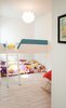 Modern home with Bedroom Room Type, Bed, Light Hardwood Floor, Bunks, Living Room, Pendant Lighting, Ceiling Lighting, and Accent Lighting. Our House - Kids' Bedroom Photo 6 of Our House