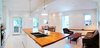 Modern home with Sofa, Coffee Tables, Ceiling Lighting, Accent Lighting, Light Hardwood Floor, Pendant Lighting, Bar, Storage, Table, Chair, and Living Room. Our House - Great Room Photo 9 of Our House