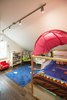 Modern home with Kids Room, Bed, Storage, Bedroom, Bookcase, and Dark Hardwood Floor. Bickford Park - Kids Room Photo 8 of Bickford Park