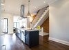 Modern home with Stone Counter, Range, Range Hood, Cooktops, Dark Hardwood Floor, Undermount Sink, Pendant Lighting, Ceiling Lighting, Wood Tread, Wood Railing, and Kitchen. Bickford Park - Kitchen Photo 11 of Bickford Park