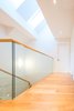 Modern home with Glass Railing, Hallway, and Medium Hardwood Floor. Edwardian Renovation - Third Floor Hallway Photo 6 of Edwardian Renovation