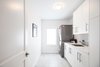 Modern home with Stacked, White Cabinet, Living Room, Pendant Lighting, and Ceiling Lighting. Edwardian Renovation - Laundry Room Photo 12 of Edwardian Renovation