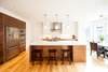 Modern home with Bar, Stools, Accent Lighting, Ceiling Lighting, Pendant Lighting, Medium Hardwood Floor, Kitchen, White Cabinet, Refrigerator, and Undermount Sink. Edwardian Renovation - Kitchen Photo 10 of Edwardian Renovation