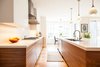 Modern home with Kitchen, White Cabinet, Medium Hardwood Floor, Ceiling Lighting, Accent Lighting, Pendant Lighting, Range Hood, Cooktops, and Undermount Sink. Edwardian Renovation - Kitchen Photo 11 of Edwardian Renovation