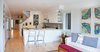 Modern home with Bar, Ceiling Lighting, Stools, Light Hardwood Floor, Sofa, Coffee Tables, Kitchen, and White Cabinet. Roncesvalles Accessible House - Great Room Photo of Roncesvalles Accessible House