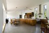 Modern home with Kitchen, Wood Cabinet, Concrete Floor, Ceiling Lighting, Track Lighting, Refrigerator, Range Hood, Range, and Wall Oven. Gananoque Lake Road House - Great Room Photo 3 of Gananoque Lake Road House