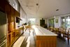 Modern home with Kitchen, Concrete Floor, Refrigerator, Wood Cabinet, Track Lighting, Microwave, and Range Hood. Gananoque Lake Road House - Great Room Photo of Gananoque Lake Road House
