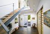 Modern home with Staircase, Wood Tread, Metal Railing, and Glass Railing. Gananoque Lake Road House - Front Foyer Photo 9 of Gananoque Lake Road House