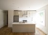 Modern home with Kitchen, White Cabinet, Medium Hardwood Floor, Accent Lighting, Ceiling Lighting, Wall Oven, Refrigerator, Cooktops, and Range Hood. 1733 Bathurst - Kitchen Photo 2 of 1733 Bathurst