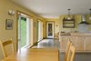 Modern home with Chair, Wall Lighting, Ceiling Lighting, Table, Kitchen, Concrete Floor, and Range Hood. Black Bank Hill - Great Room Photo 7 of Black Bank Hill