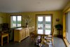 Modern home with Sofa, Chair, Dining Room, Table, Storage, Ceiling Lighting, and Concrete Floor. Black Bank Hill - Great Room Photo 6 of Black Bank Hill