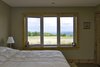 Modern home with Bedroom, Bed, Table Lighting, and Concrete Floor. Black Bank Hill - Bedroom Photo 10 of Black Bank Hill