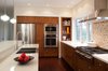 Modern home with Kitchen, Wood Cabinet, Ceiling Lighting, Pendant Lighting, Refrigerator, Wall Oven, Cooktops, Range Hood, and Microwave. Black Creek Ravine - Kitchen Photo 6 of Black Creek Ravine