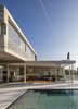 Pictured is the first house of the duplex, composed of two basic shapes that create a minimalistic and balanced composition. It contains two concrete masse, with one floating on top of the other and creates a feathery feeling despite the massive materials Photo 2 of The Dual House modern home
