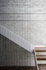 The staircase provides a central, vertical axis between the upper and lower levels. Photo 6 of The Dual House modern home