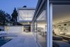 The floating mass at the top provides shading to the parts below and thus creates an outdoor space that feels like an integral part of the interior. Photo 9 of The Dual House modern home