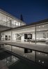Without a formal entry point, openings along the length of the lower level merge the interior and the exterior and allow a daily and unformal passage between the inside and the outside. Photo 10 of The Dual House modern home